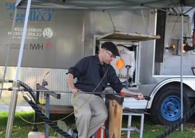 An artist blowing glass